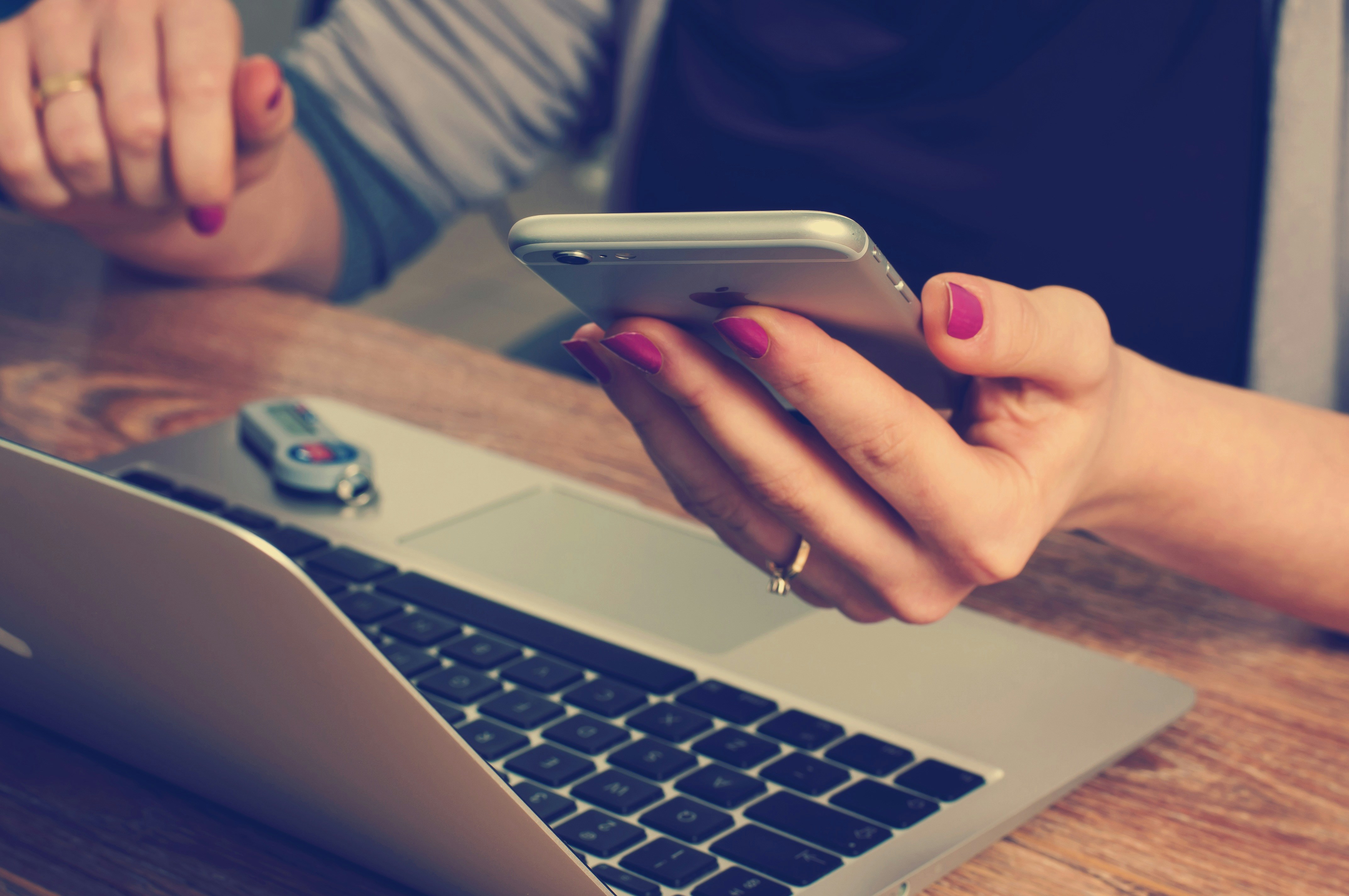 Professional managing e-commerce tasks on laptop and smartphone